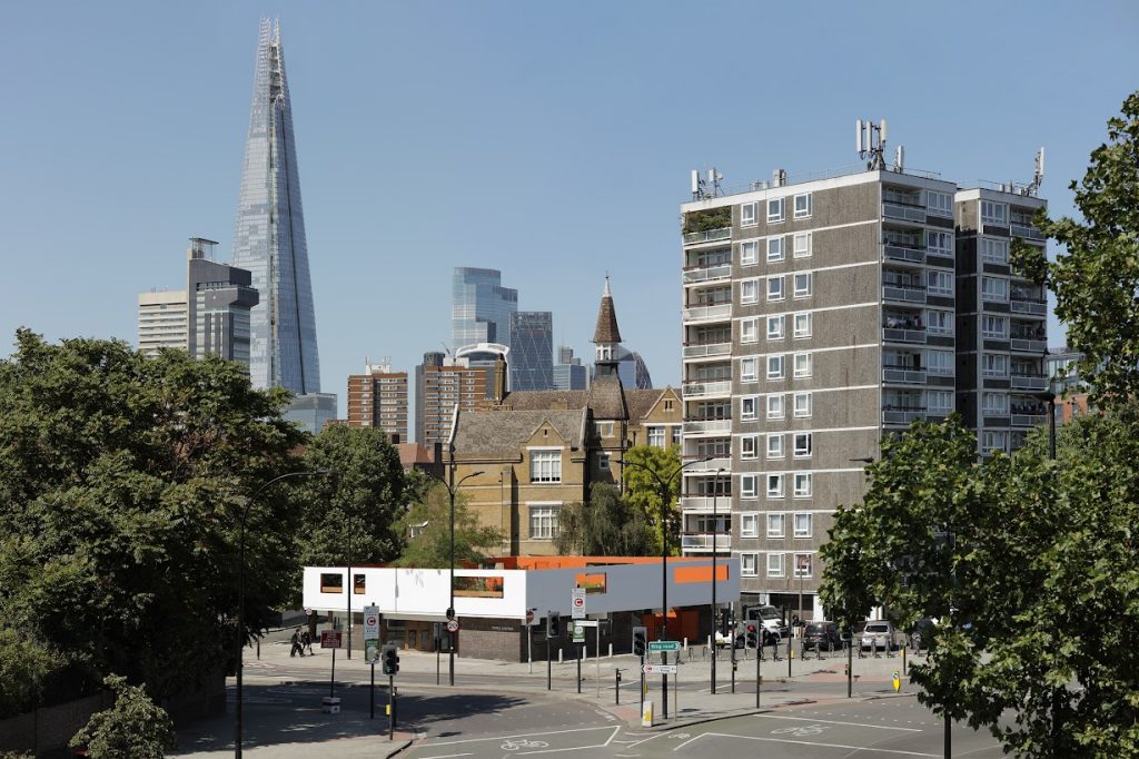 Image of the Forma building, garden above and neighbouring towerblock viewed from the Bricklayers Arms roundabout next door